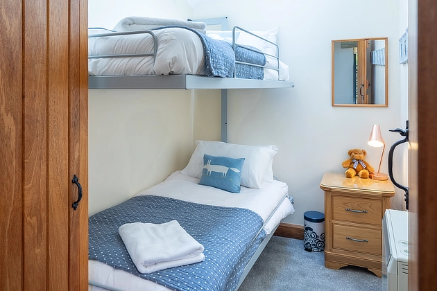 Plover Cottage's bedroom with bunk beds