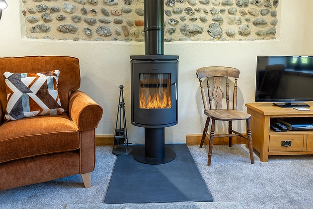 Plover Cottage's lounge diner modern fire-effect heater