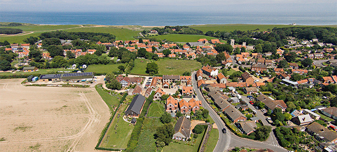 Aerial view of Home Farm Holiday Cottages looking over Weybourne to the sea